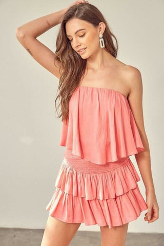 Side view of the Monaco Coral Strapless Romper showing the lightweight tiered ruffle overlay and relaxed fit