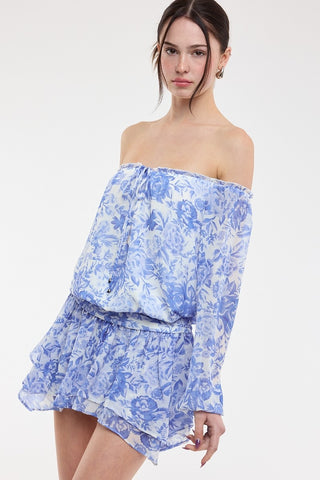 Front angled view of the Pixie Blue Floral Romper Dress highlighting the flowy chiffon fabric and blouson-style top