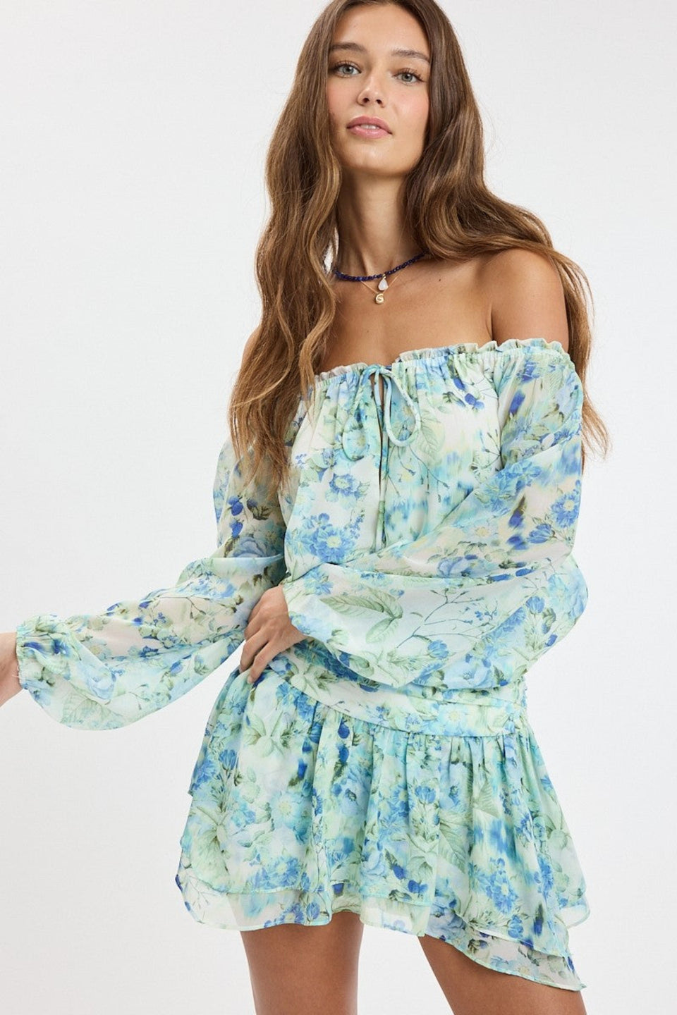 Front view of the Pixie Blue Watercolor Floral Off-the-Shoulder Romper Dress with ruffled mini skirt