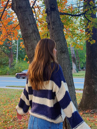 Back view of navy and white oversized striped sweater, relaxed fit