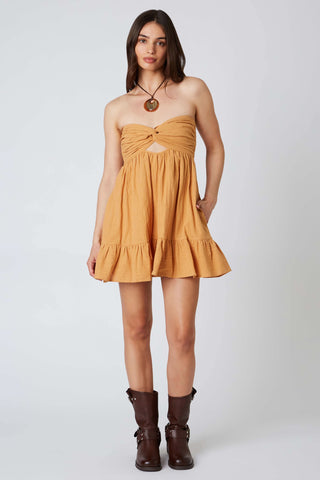 Mustard yellow strapless babydoll romper dress with twist-front bodice 