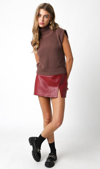 red leather micro skort outfit styled with sleeves sweater and loafers