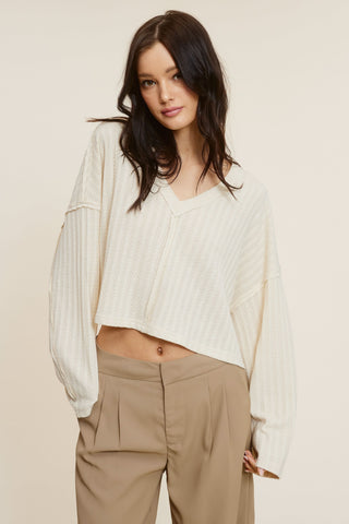 All The Way Beige Long Sleeve Crop Top showing drop shoulders and V-neckline