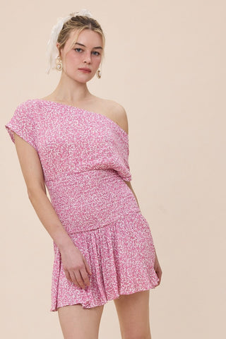 Model of woman wearing a pink floral mini dress