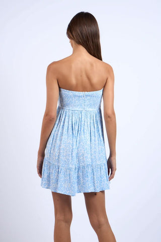 Sammie strapless mini dress in a soft blue and white cloud floral print with a tie front - back view