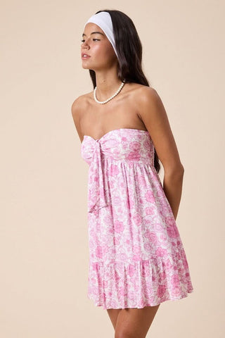 Close-up of sweetheart neckline and front tie detail on pink floral babydoll dress.
