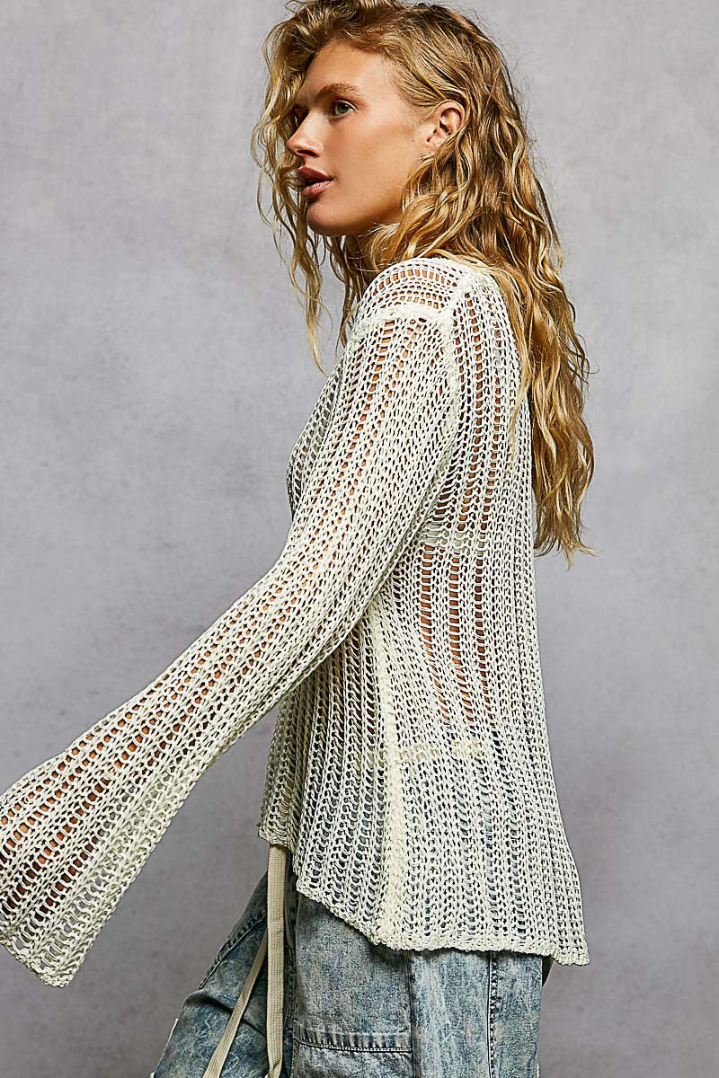 Side view of the white crochet open-knit pattern on the Sola sweater