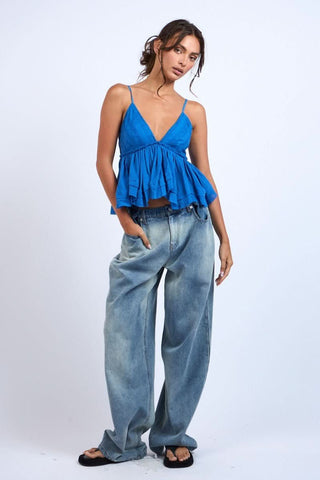 Model wearing the blue eyelet babydoll cami top for a bright, breezy summer vacation outfit.