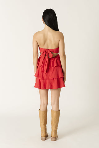 Back view of red dress featuring an adjustable self-tie bow and elastic band