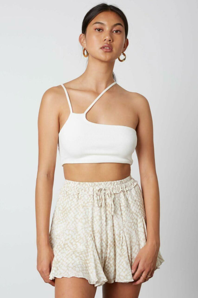 tan and white flowy print shorts front view