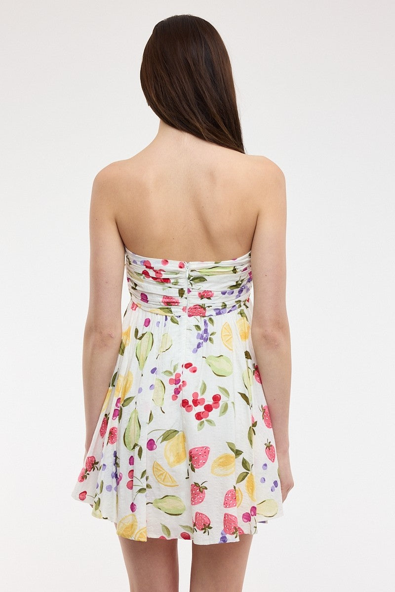 Back view of the White Fruit Print Strapless Mini Dress showing the flowy babydoll fit