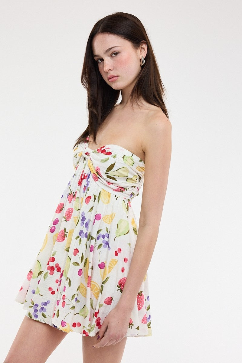 Side view of the Colette fruit print dress showing the flowy silhouette 