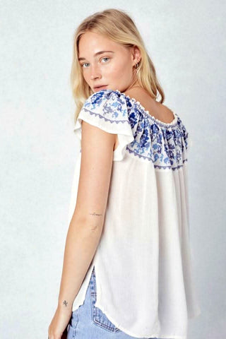 white off shoulder embroidered peasant top back view