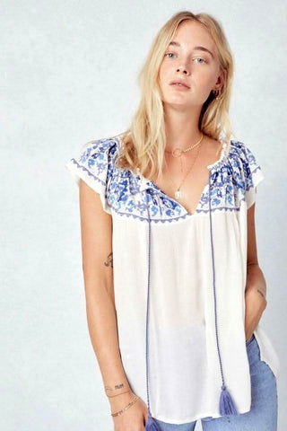 white off shoulder embroidered peasant top with tassel tie front view