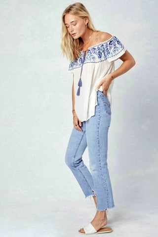 white embroidered off shoulder peasant top side view with tassel tie