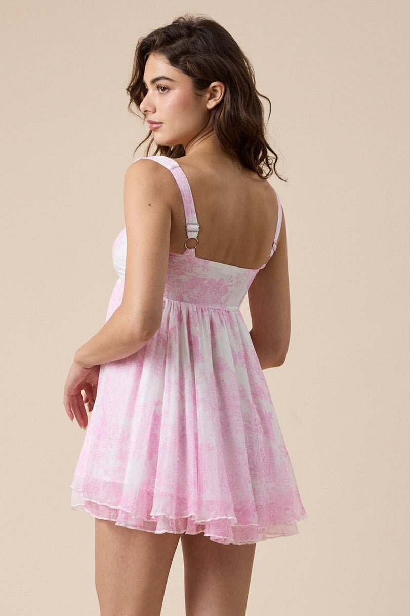 Back view of pink floral babydoll mini dress with flowy fit
