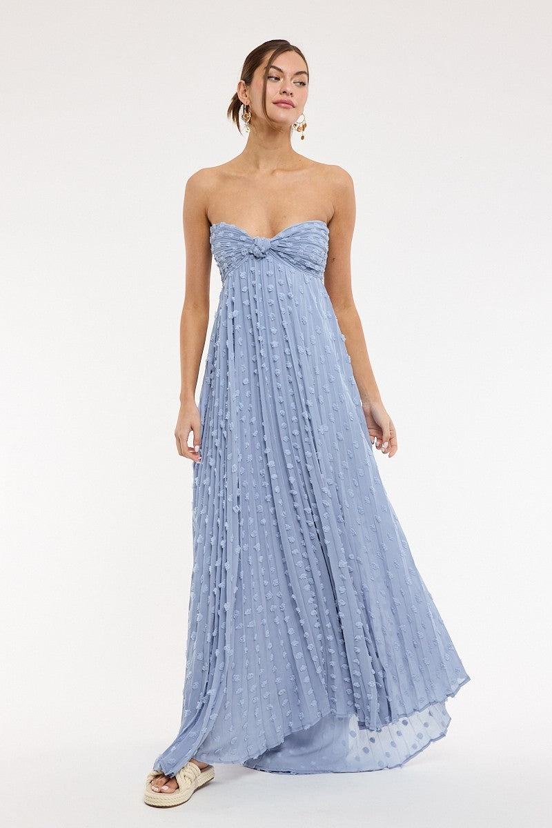 Model wearing blue clip dot strapless maxi dress