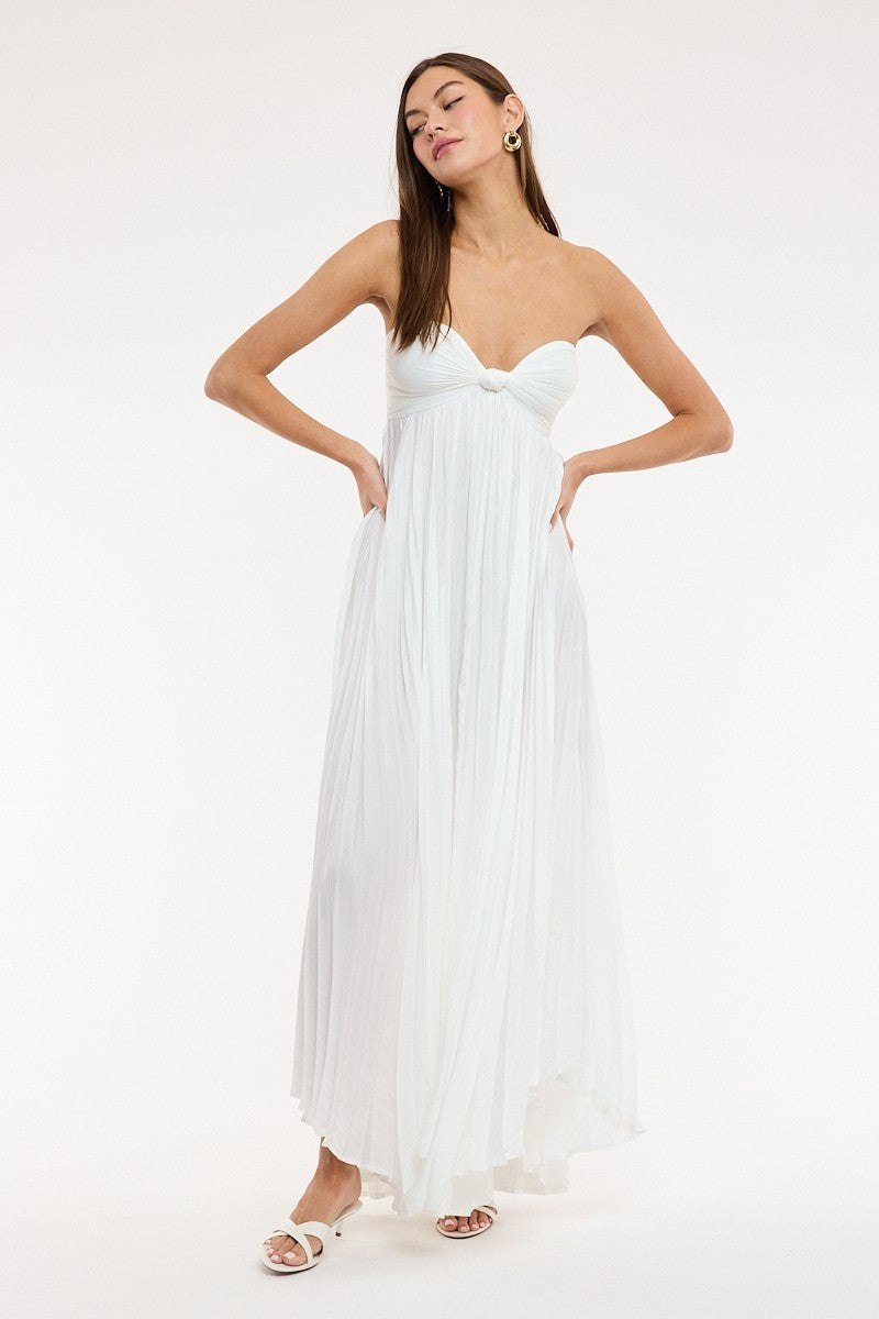  Full length view of the Willow white maxi dress highlighting the flowy pleated fabric and babydoll silhouette