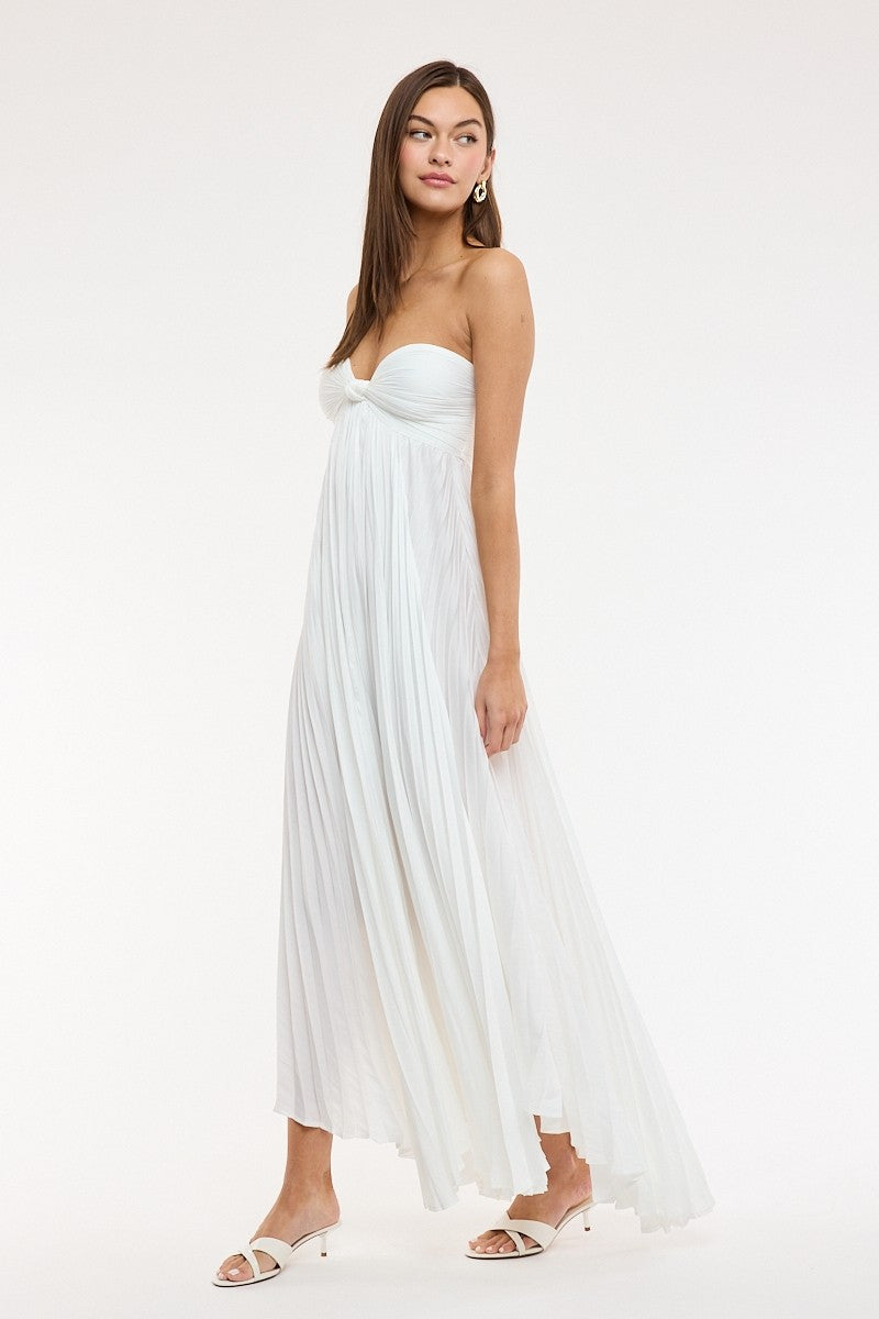 Side view of the Willow white strapless dress, styled for a casual summer look with an empire waist