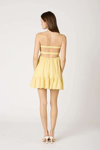 Back view of yellow gingham romper showing the stretchy smocked back 