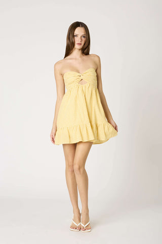 Close-up of yellow and white gingham strapless summer babydoll romper dress