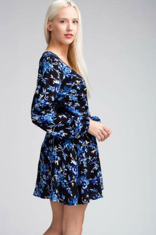 Model wearing a Black and Blue Floral Long Sleeve Dress in a photo shoot setting