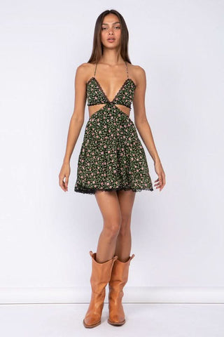 Model wearing the Garden Muse Moody Rose Print Halter Dress with cowgirl boots for a cute boho look
