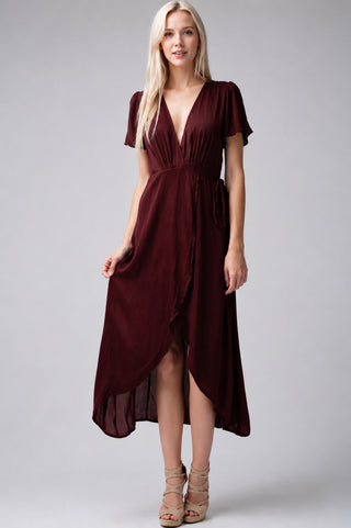 Model wearing a urgundy Midi Wrap Dress with short sleeves