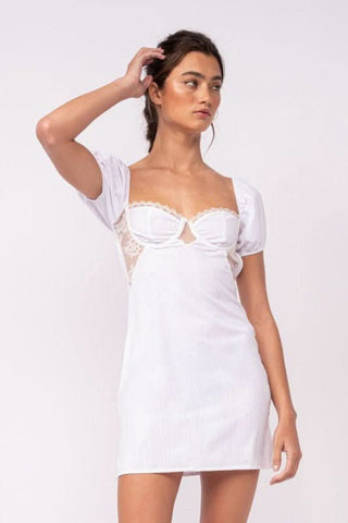 Delilah White Puff Sleeve Bustier Mini Dress one arm up front view | Boho Pink