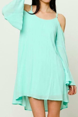 Mint cold shoulder shift dress with long bell sleeves styled for a beach vacation