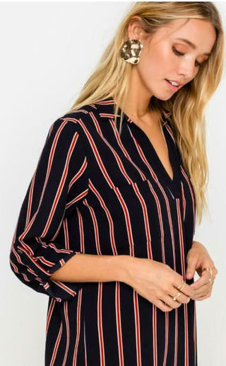 From the City Navy and Rust Striped Shirt Dress, close-up styled with gold jewelry