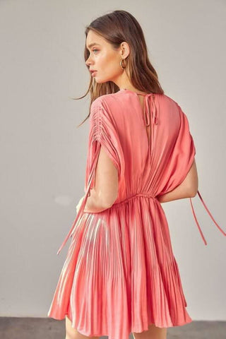 Back view: Milky pink short sleeve mini dress with flowy pleated A-line skirt