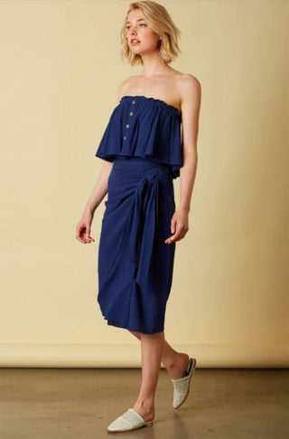 Model wearing navy two piece vacation dress with button detail