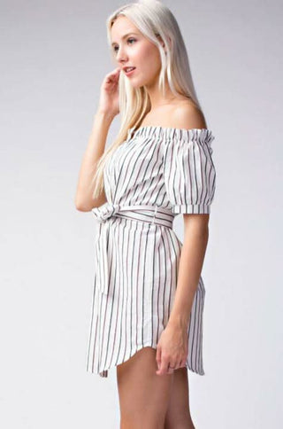 side view of beige striped off the shoulder shirt dress styled for summer