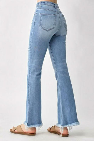 Back view of high rise flare jeans showing the five pocket cut and figure hugging fit