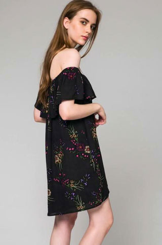 Model wearing a black floral off-the-shoulder dress for a summer backyard praty | Boho Pink