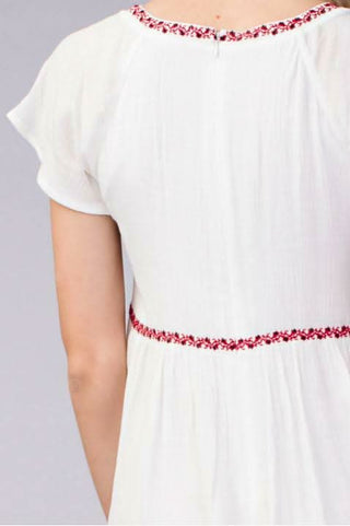 Detail of embroidered empire waist on white gauze babydoll dress