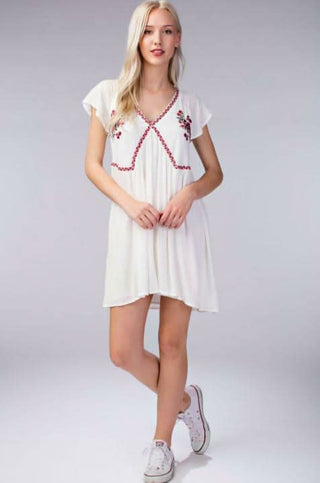 White embroidered babydoll dress with short sleeves and empire waist
