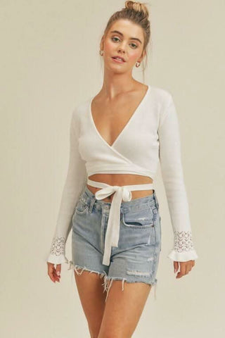 Cropped wrap sweater styled with distressed shorts