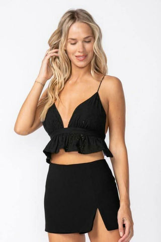 Jenny Black Eyelet Backless Ruffle Crop Top styled with a black mini skirt