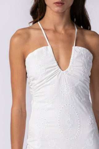 closeup view of white eyelet lace dress with criss-cross tie straps