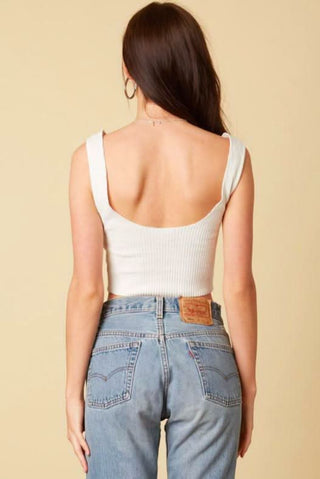 White cropped tank top styled with denim shorts - back view