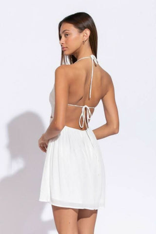 Back view of Monika White Cutout Halter Mini Dress showing open back design and adjustable halter tie strings