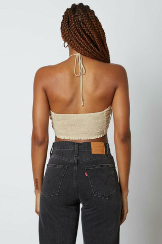 Back view of a jute halter crop top showing the tie-neck closure 