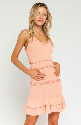 Rhea Peach Blush Smocked Ruffle Mini Dress with V-neckline and tiered ruffle hem