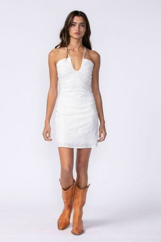 white eyelet graduation dress with halter neck and open back styled for graduation