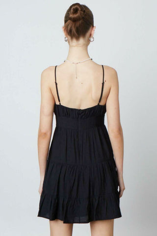 Black flowy babydoll mini dress with spaghetti straps - back view