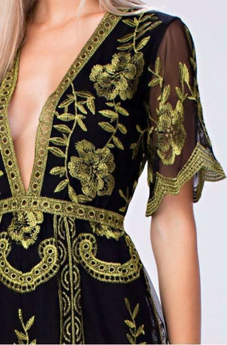 Closeup of gold & black lace deep V-romper emboidery 