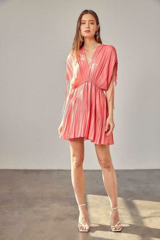 Model wearing milky pink pleated mini dress styled for sorority rush and summer parties
