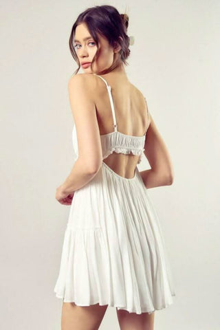 Back view of Dani white backless ruffle dress with cutout